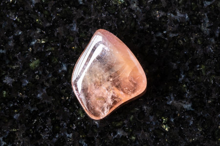 sample of tumbled pink tourmaline crystal on black granite background close up from Brazilの写真素材