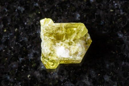 sample of raw chrysoberyl mineral on black granite background close up from Madagascarの写真素材