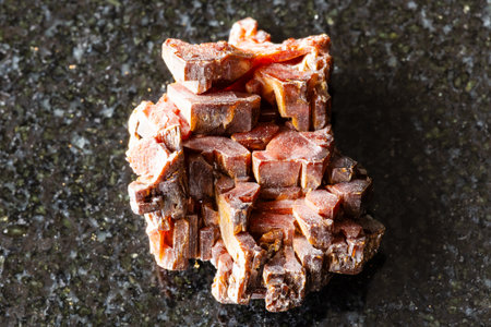 sample of rough vanadinite rock on black granite background close up from Mibladen, Moroccoの写真素材