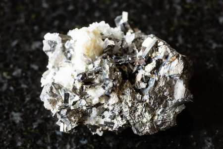 sample of rough arsenopyrite rock on black granite background close up from Primorye, Russiaの写真素材