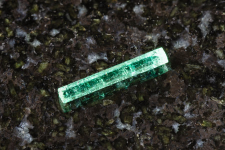 sample of rough emerald crystal on black granite background close up from Afghanistanの写真素材