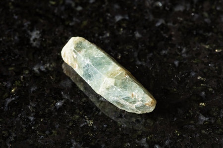 sample of rough green sapphire corundum crystal on black background close upの写真素材