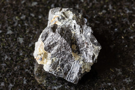 sample of rough wolframite rock on black granite background close up from Altai, Russiaの写真素材