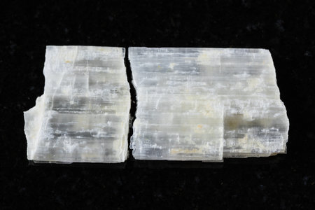 sample of rough eudidymite mineral on black granite background close up from Malawiの写真素材