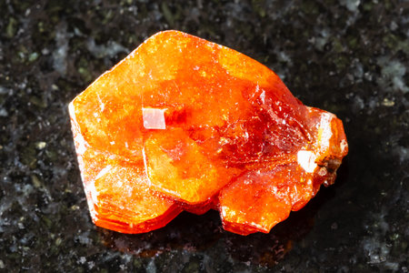 sample of raw vanadinite crystal on black granite background close up from Mibladen, Moroccoの写真素材