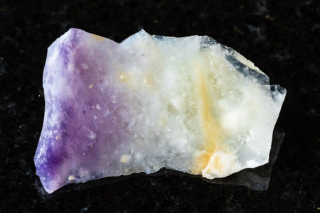 sample of rough opal mineral on black granite background close up from Mexicoの写真素材