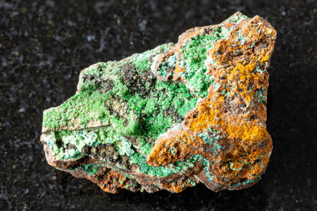 sample of raw conichalcite crystals on limonite rock on black granite background close up from Mexicoの写真素材