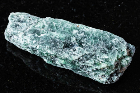 sample of raw green kyanite mineral on black granite background close up from Madagascarの写真素材