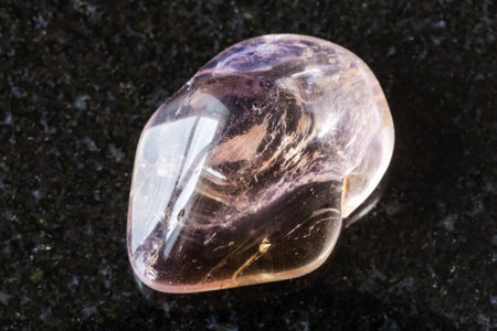 sample of polished ametrine mineral on black granite background close up from Brazilの写真素材