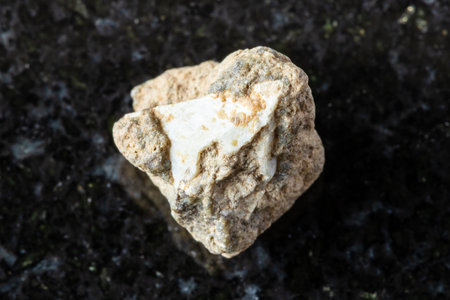 sample of rough achtarandite mineral on black granite background close up from Akhtaranda, Yakutia, Russiaの写真素材