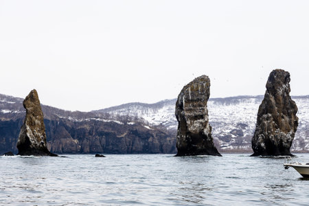 Three Brothers rocks in Avacha bay in Pacific ocean on spring day near Petropavlovsk-Kamchatsky...