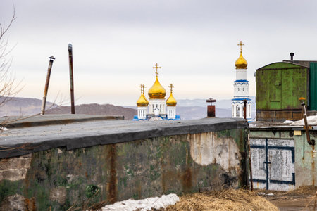 urban yard and houses of church in Petropavlovsk-Kamchatsky city on spring day, Kamchatka Krai,...