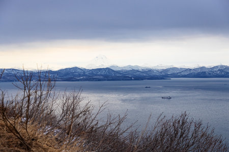 above view of Avacha Bay near Petropavlovsk-Kamchatsky city from Mishennaya sopka on overcast spring evening, Kamchatka Krai, Russiaの写真素材