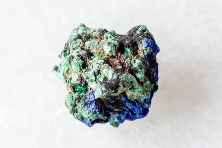 sample of unpolished azurite and malachite mineral on white marble background close upの写真素材