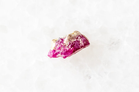 sample of rough pink ruby mineral on white marble background close up from Pakistanの写真素材