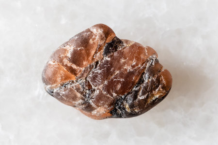 sample of rawtriplite mineral on white marble background close up from Pakistan