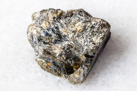 sample of raw dark green labradorite mineral on white marble background close upの写真素材