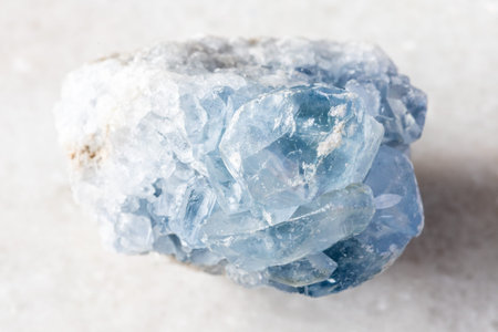 sample of raw celestite mineral on white marble background close up from Madagascar