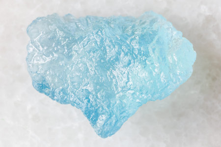 sample of raw aquamarine mineral on white background close up