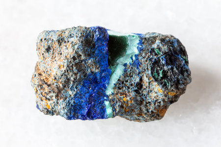 sample of rough azurite and malachite mineral on white marble background close up