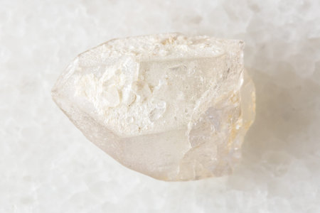 sample of raw rock-crystal on white marble background close up from Bashkiria, Russia