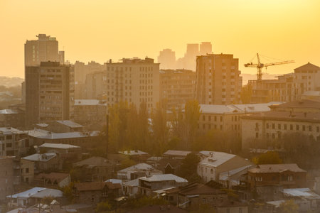 top view of urban houses in Kentron district in Yerevan city at smoggy autumn sunset from Cascade Monumentの写真素材