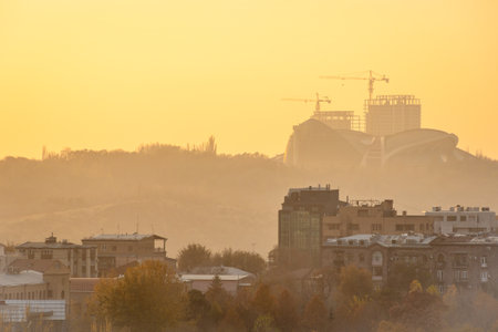 above view of buildings in Yerevan city in yellow hazy autumn sunsetの写真素材
