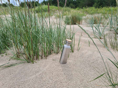 Water bottle in the seaside dunesの写真素材