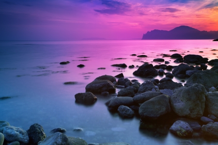 Sunset over a rocky coastの写真素材
