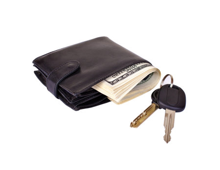 Black purse stuffed with paper money and car keys isolated on white background