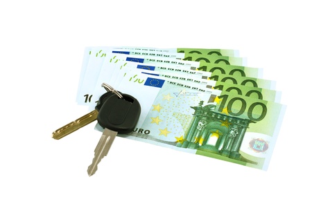 Car keys on euro banknotes isolated on white backgroundの写真素材