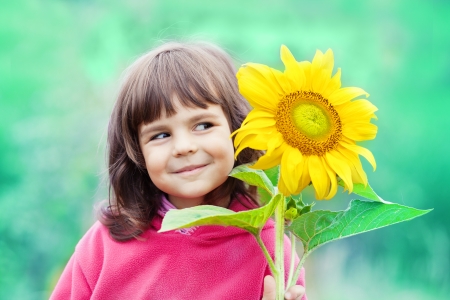 Little girl with sunflowerの写真素材