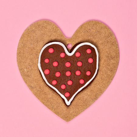 Heart shaped cookies on wooden heartの写真素材