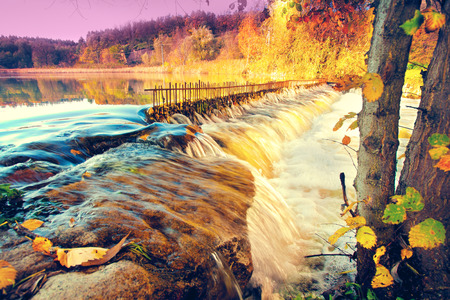 River with waterfall in autumnの写真素材