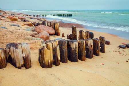 Desert beach with old wooden columnの写真素材
