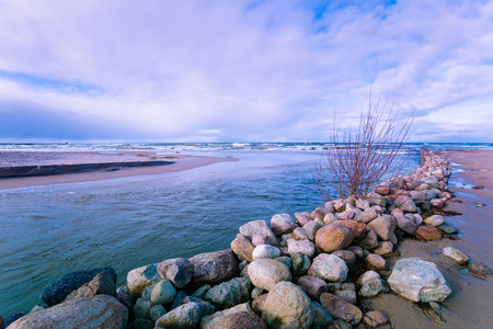 Delta in the daytime. Rocky bank of river. The river flows into the sea;の写真素材
