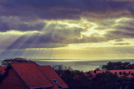 Sunset over the village, located on the sea shoreの写真素材