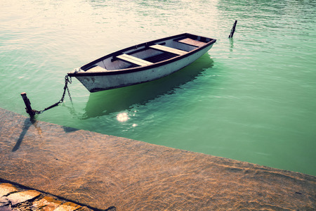 Morning on the lake. Boat near pierの写真素材
