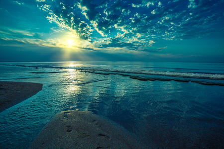 Early morning, sunrise over beach. River delta on the sea shoreの写真素材