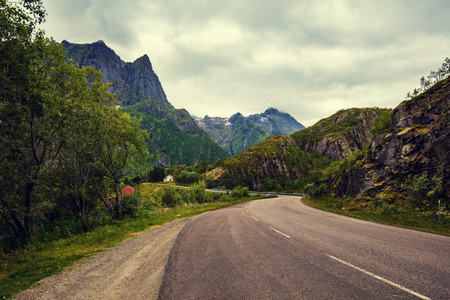 Mountain road with cloudy sky. The view through the windshieldの写真素材