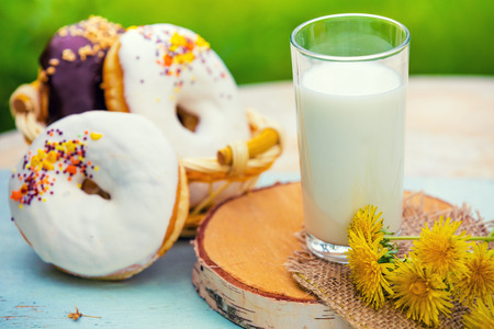 Glass of milk with donuts outdoorの写真素材