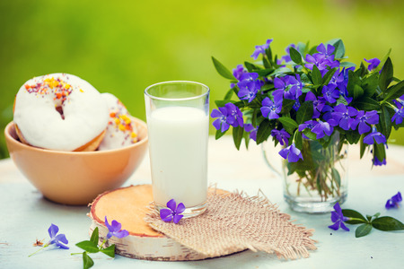 Glass of milk with donuts outdoorの写真素材