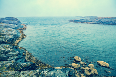 Rocky beach. Atlantic shore in the misty morning. Sea coast. Beautiful wilderness Norwayの写真素材