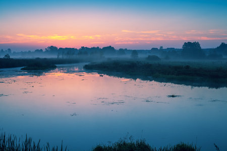 Early morning, dawn over the lake. Misty morning, rural landscape, wilderness, mystical feeling