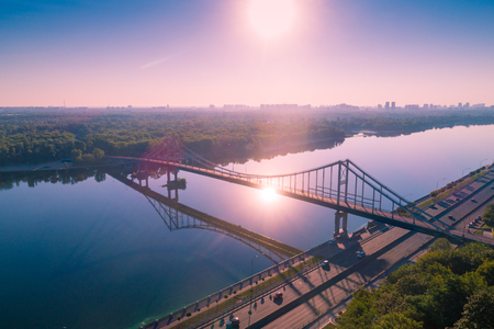 City of Kiev with a beautiful morning sky. Pedestrian bridge. The left bank of the Dnieper. Bird's-eye. Sunrise over the cityの写真素材