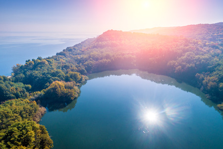 Picturesque mountain lake in autumn at sunrise. Lake near the sea. Beautiful wild nature. Aerial viewの写真素材