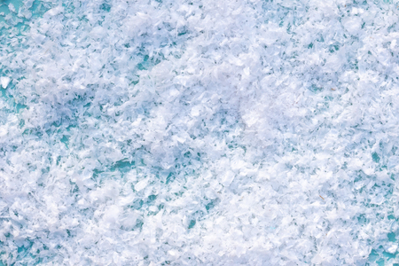 Abstract winter background. Ðrtificial snow on blue backgroundの写真素材
