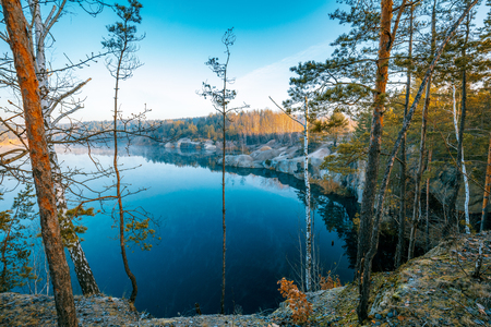 Rocky shore of a mountain lake on a misty autumn morning. Beautiful nature of Norwayの写真素材