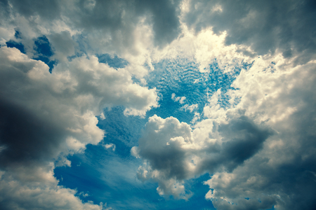 Dramatic cloudy sky. The sun shines through the cloudsの写真素材