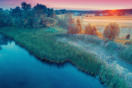 Aerial view of countryside and brook in the evening at sunset lightの写真素材